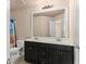 Bright bathroom with double sinks, well-lit vanity mirror, and combined shower and tub at 1212 Lake Point Way, Suwanee, GA 30024