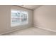 Bedroom with a neutral color scheme and window views of the neighborhood at 1212 Lake Point Way, Suwanee, GA 30024