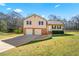 Charming two-story home featuring a two-car garage and a well-maintained front yard at 135 Tanyard Ct, Newborn, GA 30056