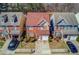 Aerial view of two-story brick home with manicured lawn and driveway surrounded by neighboring houses at 1554 Park Grove Dr, Lawrenceville, GA 30046