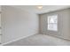 Neutral bedroom featuring carpeted floors, a window, and a neutral color palette at 1554 Park Grove Dr, Lawrenceville, GA 30046