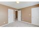 Neutral bedroom featuring carpeted floors, two closets, and a neutral color palette at 1554 Park Grove Dr, Lawrenceville, GA 30046
