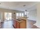 Open-concept kitchen featuring wood floors, stainless sink and view into the living room at 1554 Park Grove Dr, Lawrenceville, GA 30046