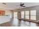 Bright living room with wood floors, ceiling fan and natural light from windows to a patio at 1554 Park Grove Dr, Lawrenceville, GA 30046