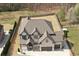 Aerial view highlighting the home's spacious lot, lush landscaping, and private fenced backyard at 1952 Azalea Dr, Lawrenceville, GA 30043