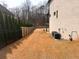 A view of the back corner of the home that highlights the property line and surrounding woods at 1952 Azalea Dr, Lawrenceville, GA 30043