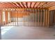Unfinished basement featuring exposed framing, concrete walls, and natural light at 1952 Azalea Dr, Lawrenceville, GA 30043
