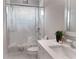 A clean, well-lit bathroom features a modern vanity, shower with patterned curtain, and tile flooring at 1952 Azalea Dr, Lawrenceville, GA 30043
