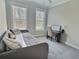 Comfortable bedroom with a daybed, carpet, and natural light from two windows at 1952 Azalea Dr, Lawrenceville, GA 30043