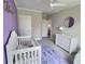 Charming bedroom with purple accent wall, plush lavender rug, and ample natural light at 1952 Azalea Dr, Lawrenceville, GA 30043