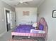 Well-lit bedroom with a pink bed, shiplap accent wall, and neutral decor at 1952 Azalea Dr, Lawrenceville, GA 30043