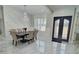 Bright dining room with marble floors, a decorative chandelier, and a modern rectangular dining table at 1952 Azalea Dr, Lawrenceville, GA 30043