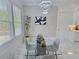 Bright dining area with a modern chandelier, large windows, and contemporary furnishings at 1952 Azalea Dr, Lawrenceville, GA 30043