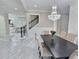 An open-concept dining room features white marble floors and seamlessly connects to the staircase and living area at 1952 Azalea Dr, Lawrenceville, GA 30043