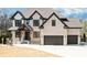 Beautiful two-story brick home features a three-car garage and inviting covered front porch at 1952 Azalea Dr, Lawrenceville, GA 30043