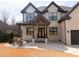 Charming covered front porch and beautiful glass and iron front door creating a welcoming entrance at 1952 Azalea Dr, Lawrenceville, GA 30043