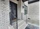 Close-up showcasing the wrought iron front door, brickwork, and metal handrails at 1952 Azalea Dr, Lawrenceville, GA 30043