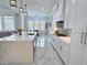 Spacious kitchen featuring a large island with a sink, white cabinets, and marble countertops at 1952 Azalea Dr, Lawrenceville, GA 30043