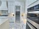 Bright kitchen featuring white cabinets, stainless steel appliances, and marble tile flooring with pantry access at 1952 Azalea Dr, Lawrenceville, GA 30043