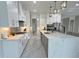 Open kitchen with stainless steel appliances, gray and white cabinets, and marble flooring at 1952 Azalea Dr, Lawrenceville, GA 30043