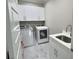 Functional laundry room with white cabinets, sink, and modern washer and dryer units at 1952 Azalea Dr, Lawrenceville, GA 30043