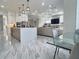 Open-concept design showcasing the kitchen, dining area, and living room with modern lighting at 1952 Azalea Dr, Lawrenceville, GA 30043