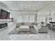 Spacious living room with tray ceilings, marble floors, a large sectional sofa, and a stone fireplace at 1952 Azalea Dr, Lawrenceville, GA 30043