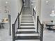 Staircase leading to an open-concept living area with a dining room at 1952 Azalea Dr, Lawrenceville, GA 30043