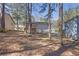 Expansive backyard featuring mature trees and a deck, perfect for outdoor activities and relaxation at 2044 Teal Cv, Lithonia, GA 30058