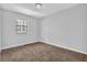 Bright bedroom featuring neutral walls, carpet, and a window for natural light at 2044 Teal Cv, Lithonia, GA 30058