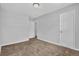 Bedroom showcasing neutral walls, carpet, and a view into the hallway at 2044 Teal Cv, Lithonia, GA 30058