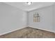 Cozy bedroom with neutral walls and carpet, plus a window allowing natural light at 2044 Teal Cv, Lithonia, GA 30058