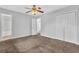 Spacious bedroom with neutral walls, carpet, a ceiling fan, and closet for ample storage at 2044 Teal Cv, Lithonia, GA 30058