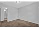 Bedroom with neutral walls and carpet, plus a doorway leading to another room at 2044 Teal Cv, Lithonia, GA 30058