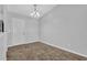 Dining room area with neutral walls, carpet, and a chandelier fixture at 2044 Teal Cv, Lithonia, GA 30058