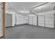 Spacious garage with an access door and a white sectional garage door at 2044 Teal Cv, Lithonia, GA 30058