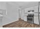 This is a bright kitchen featuring stainless appliances, white cabinets and a gas range on wood-look flooring at 2044 Teal Cv, Lithonia, GA 30058