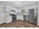 Bright kitchen featuring stainless steel appliances, new countertops, and wood look flooring at 2044 Teal Cv, Lithonia, GA 30058