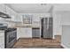 Kitchen features white cabinets, modern appliances and wood floors at 2044 Teal Cv, Lithonia, GA 30058