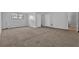 Inviting living room featuring neutral carpet, paint, and two entry doors at 2044 Teal Cv, Lithonia, GA 30058