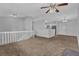 Living room with carpet, a ceiling fan, and a view into the kitchen at 2044 Teal Cv, Lithonia, GA 30058