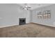 Living room features neutral walls, carpet, fireplace, and bright natural light at 2044 Teal Cv, Lithonia, GA 30058