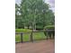 Spacious back deck overlooking a lush, green backyard with mature trees and a dark fence at 2467 Sky Valley Dr, Dacula, GA 30019