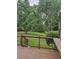 An outdoor deck with dark railings overlooks a spacious green backyard with mature trees at 2467 Sky Valley Dr, Dacula, GA 30019