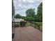 Back deck features deck boards, dark railings, and offers views of the lush green backyard at 2467 Sky Valley Dr, Dacula, GA 30019