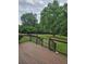 Composite deck with dark railings overlooking the lush yard and mature trees at 2467 Sky Valley Dr, Dacula, GA 30019