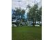 Large backyard featuring a well-maintained lawn, mature trees, and a view of the rear of the home at 2467 Sky Valley Dr, Dacula, GA 30019