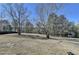 Expansive backyard featuring mature trees, and a storage shed at 2467 Sky Valley Dr, Dacula, GA 30019