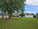 Expansive backyard with lush lawn and mature trees offering a view of the house and deck at 2467 Sky Valley Dr, Dacula, GA 30019