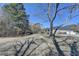 Vast backyard with distant view of the home and detached garage at 2467 Sky Valley Dr, Dacula, GA 30019